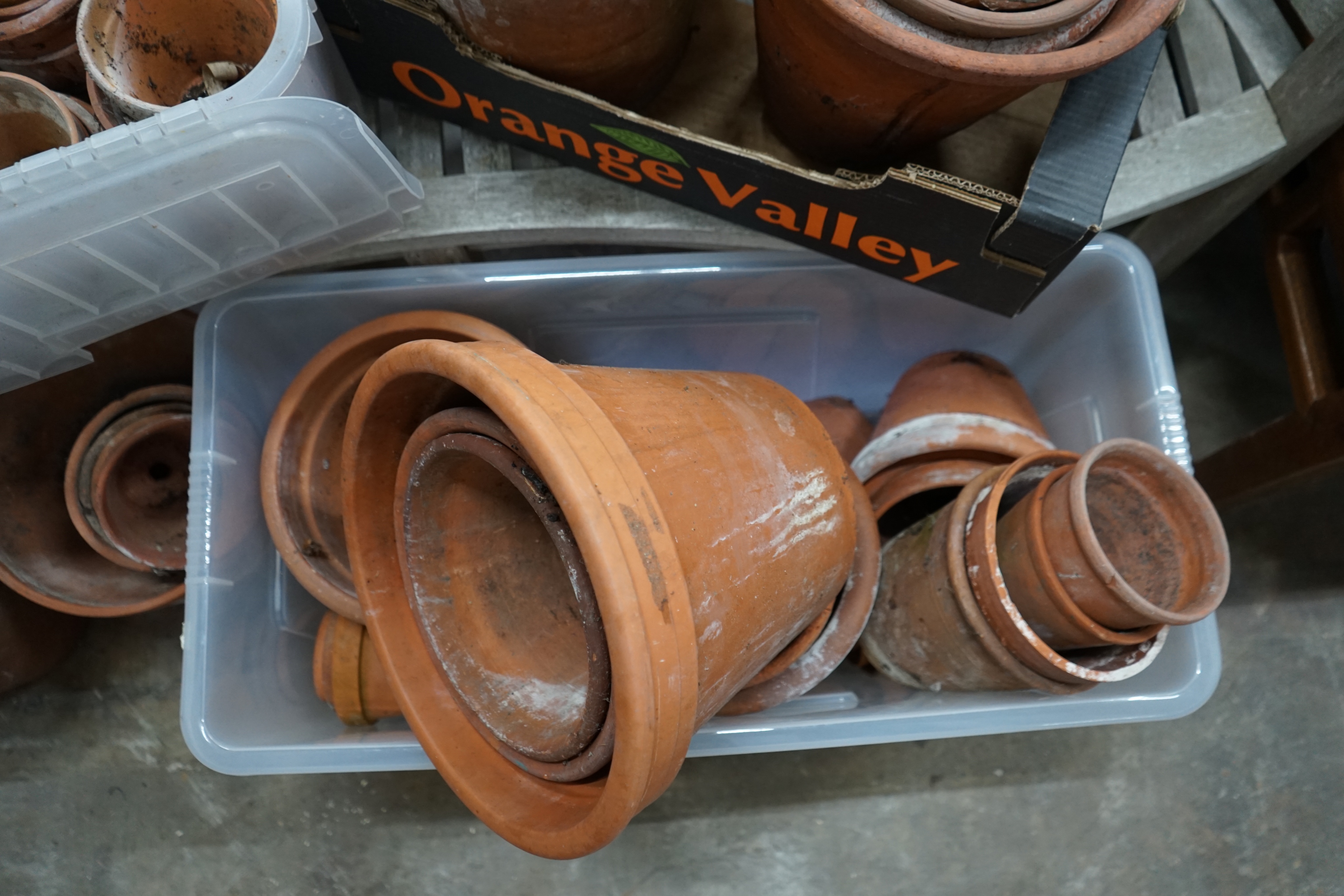 Approximately 100 terracotta garden pots, largest diameter 33cm height 28cm